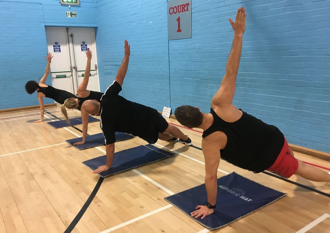 people exercising in a sports hall 